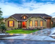 green bungalow with dark gray roof