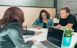couple reviewing paperwork with consultant