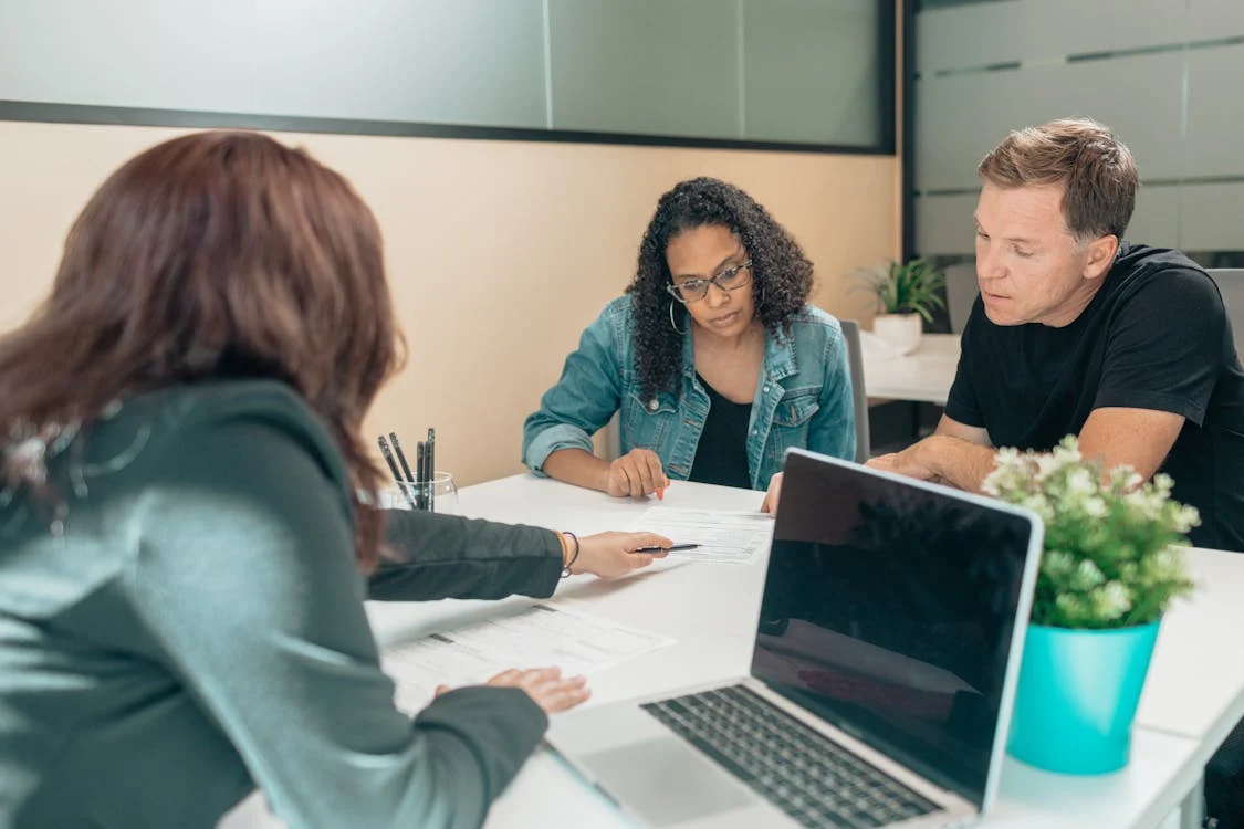couple reviewing paperwork with consultant