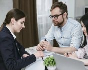 Couple going over paperwork with a business woman