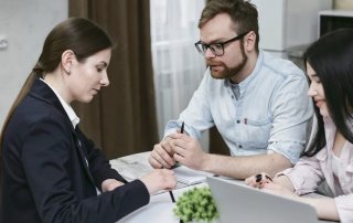 Couple going over paperwork with a business woman